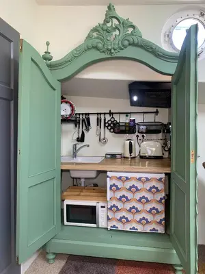 a green cabinet with a sink in a kitchen at Appartement op woonboot hartje centrum in Amsterdam