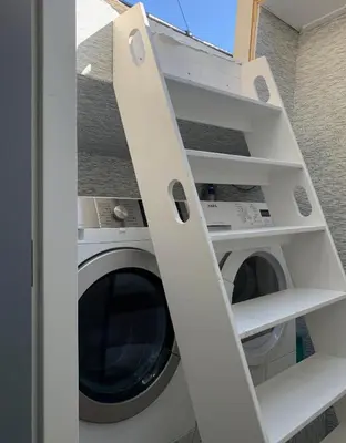 a white washer and dryer in a room at Appartement op woonboot hartje centrum in Amsterdam