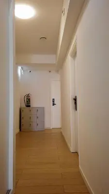 an empty hallway with a dresser in a room at Y Hostel in Amsterdam
