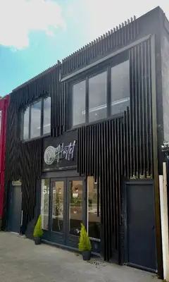 a black building with windows on the side of it at Y Hostel in Amsterdam