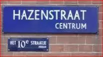 a blue sign on the side of a brick wall at Jordaan Suite bed and bubbles in Amsterdam