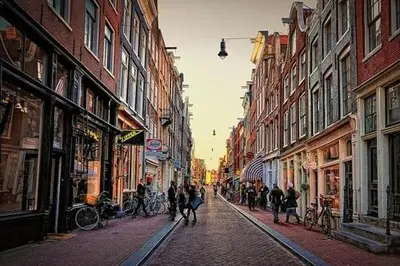 a group of people walking down a city street at Jordaan Suite bed and bubbles in Amsterdam