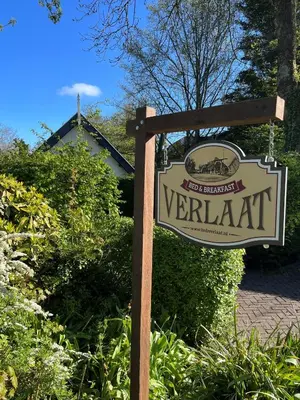 a sign for a verkat restaurant in front of a house at Bed and Breakfast Verlaat in Oude-Niedorp