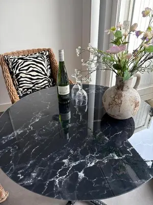 a bottle of wine sitting on a glass table at Studio Sunrise in Zandvoort