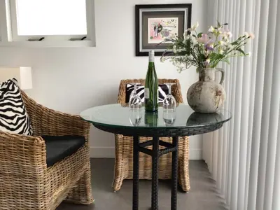 a dining room table with a vase of flowers on it at Studio Sunrise in Zandvoort