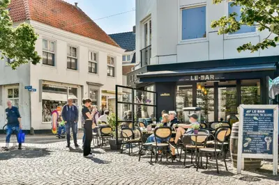 a group of people sitting in chairs in a street at Loft Studio's in Zandvoort