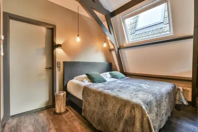 a bedroom with a bed and a window at Loft Studio's in Zandvoort