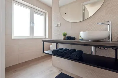 a bathroom with a sink and a mirror at Short Stay Zandvoort at 68 in Zandvoort