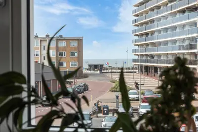 a window with a view of a parking lot and a building at Short Stay Zandvoort at 68 in Zandvoort