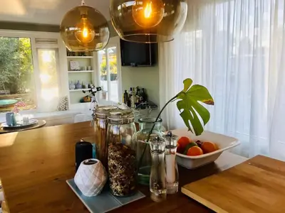 a kitchen counter with glass jars and a bowl of fruit at Amsterdam lake area, super wifi island incl boat in Vinkeveen