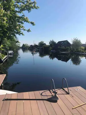 a dock with a view of a lake at Amsterdam lake area, super wifi island incl boat in Vinkeveen