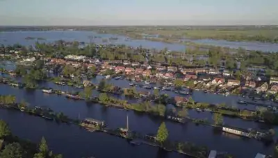 an aerial view of a river with houses at Amsterdam lake area, super wifi island incl boat in Vinkeveen