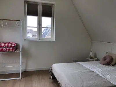 a bedroom with a bed and a window at House with garden in Amsterdam in Weesp