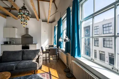 a living room with a couch and a table at Barbera Guesthouse Hotel Apartments - Experience local life in the Old Centre in Haarlem