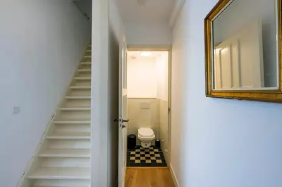a bathroom with a staircase with a toilet and a mirror at Barbera Guesthouse Hotel Apartments - Experience local life in the Old Centre in Haarlem