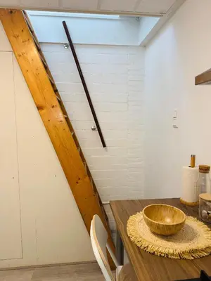 a wooden bowl on a table in a room at tiny beach house noordwijk in Noordwijk aan Zee