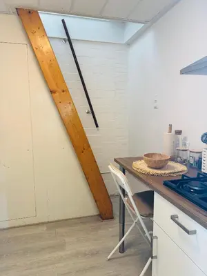 a kitchen with a table with a bowl on a counter at tiny beach house noordwijk in Noordwijk aan Zee