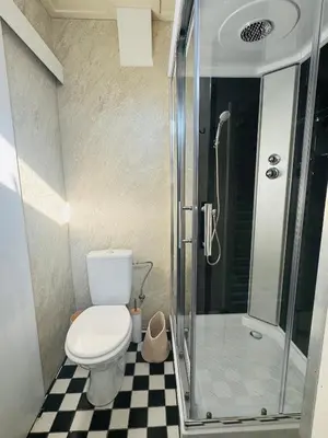a bathroom with a toilet and a shower at tiny beach house noordwijk in Noordwijk aan Zee