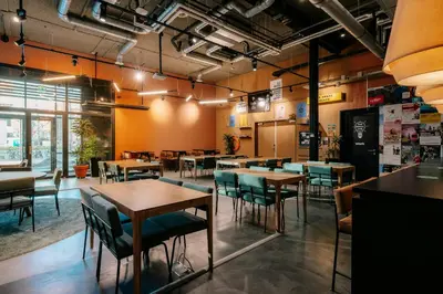 a restaurant with tables and chairs in a room at The Social Hub Amsterdam City Extended Stay in Amsterdam
