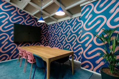 a conference room with a table and chairs and a wall at The Social Hub Amsterdam City Extended Stay in Amsterdam