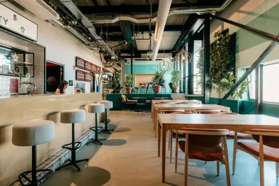 a restaurant with tables and chairs and a bar at The Social Hub Amsterdam City Extended Stay in Amsterdam