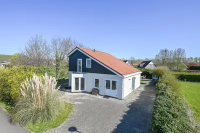a black and white house with a driveway at Villa NovaTerra - Zeewolde in Zeewolde