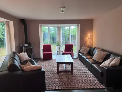 a living room with couches and a coffee table at Villa NovaTerra - Zeewolde in Zeewolde