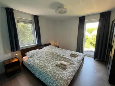 a bedroom with a bed with two pillows on it at Villa NovaTerra - Zeewolde in Zeewolde