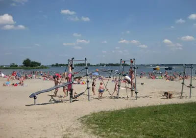 a group of people playing on the beach at Villa NovaTerra - Zeewolde in Zeewolde