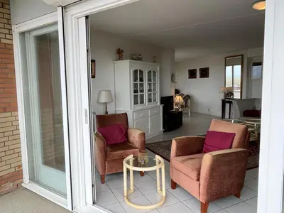 a living room with two chairs and a table at Atlantis 14a in Egmond aan Zee