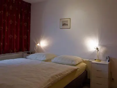 a bedroom with a bed with two pillows at Atlantis 14a in Egmond aan Zee