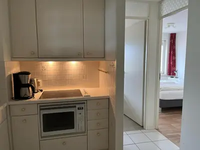 a kitchen with a sink and a microwave at Atlantis 14a in Egmond aan Zee