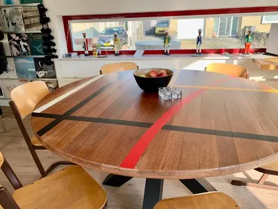 a wooden table with a bowl of fruit on top at Heerlijke villa met zwembad en sauna bij het strand in Bergen aan Zee