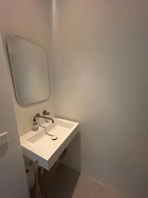 a bathroom with a white sink and a mirror at Spacious and lovely home in Amsterdam