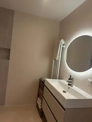 a bathroom with a white sink and a mirror at Spacious and lovely home in Amsterdam