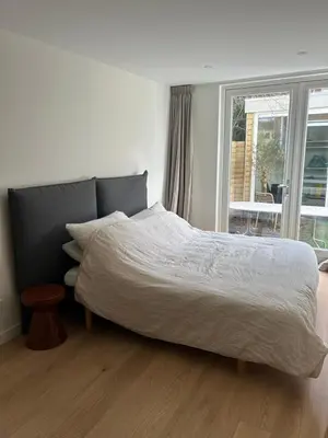 a bedroom with a bed and a window at Spacious and lovely home in Amsterdam