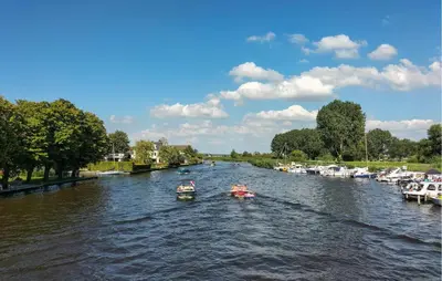 two boats in a river with manyocked boats at Gorgeous Home In Vinkeveen With Sauna in Vinkeveen