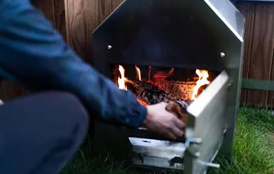 a person sitting in front of a fireplace at Gorgeous Home In Vinkeveen With Sauna in Vinkeveen