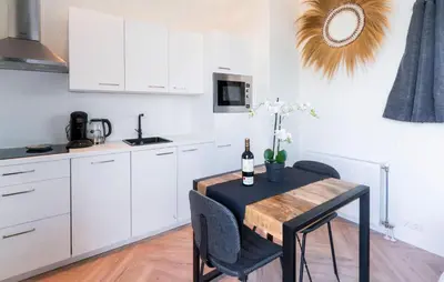 a kitchen with a table with a bottle of wine at Beautiful Home In Vinkeveen With Sauna in Vinkeveen