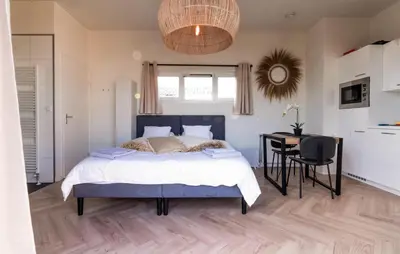 a bedroom with a bed and a desk and a table at Beautiful Home In Vinkeveen With Sauna in Vinkeveen