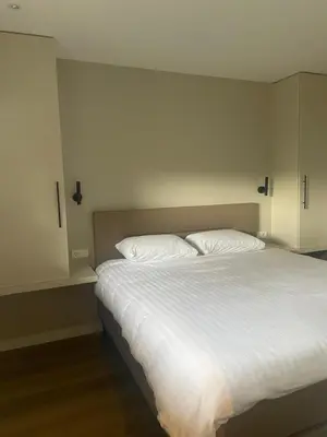 a bedroom with a white bed with two pillows at Studio 137 in Zwaag