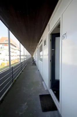 an empty hallway of a building with the number at Casa Luma in Zandvoort