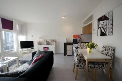 a living room with a couch and a table at Casa Luma in Zandvoort