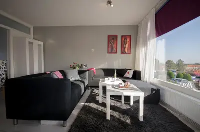 a living room with a couch and a table at Casa Luma in Zandvoort