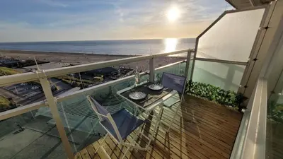 a balcony with a view of the beach and the ocean at Aladdin's Sky in Zandvoort