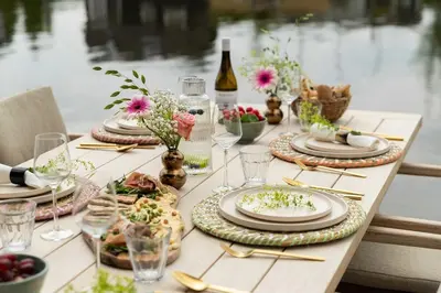 a table with plates of food and flowers on it at Guesthouse De Waterliefde Loosdrecht in Breukelen