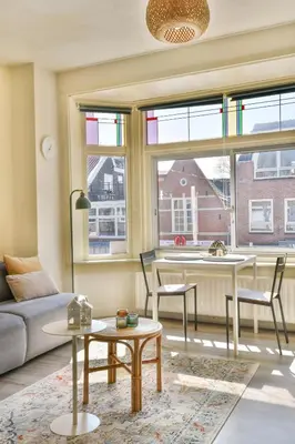 a living room with a couch and a table at Studio la Riet in Alkmaar