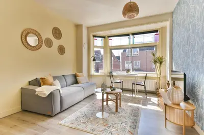 a living room with a couch and a table at Studio la Riet in Alkmaar