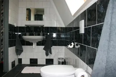 a bathroom with a toilet and a sink at Appartement De Molshoop in Landsmeer