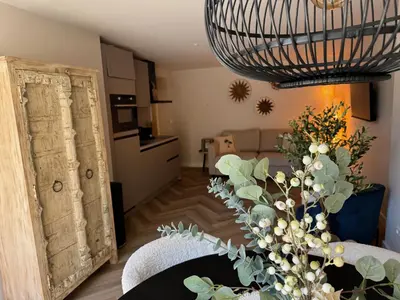 a living room with a table with a vase of flowers at Short Stay Zandvoort at 68A in Zandvoort